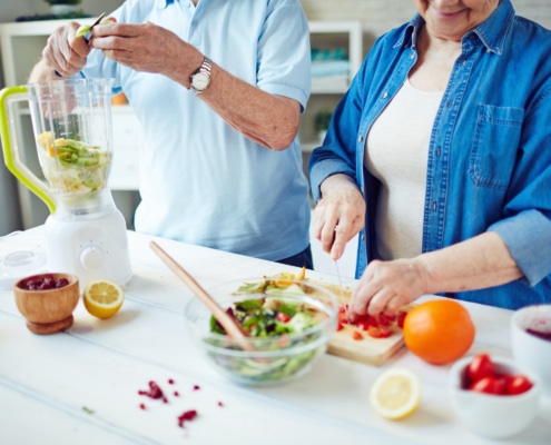senior couple preparing food for brain health