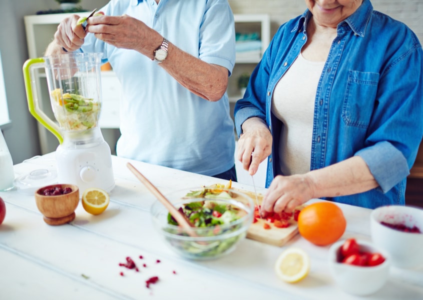 senior couple preparing food for brain health
