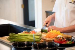 Personal chef chopping vegetables.