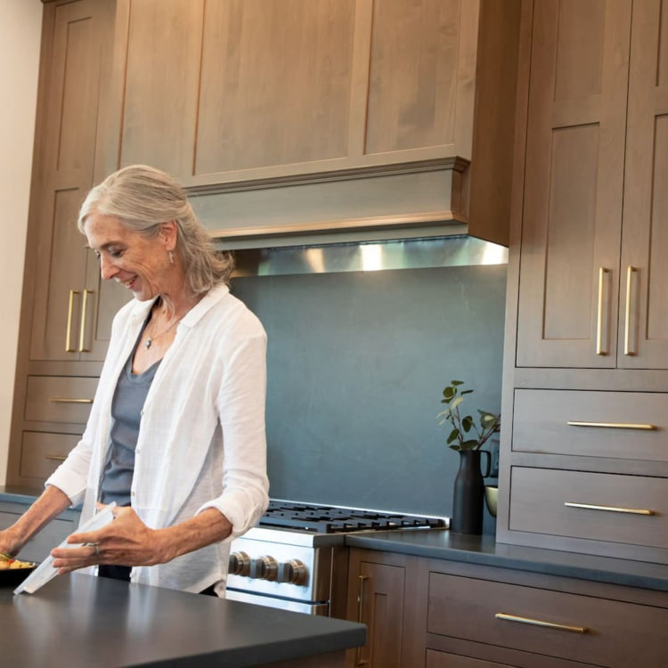 Older woman opened a meal in a plastic container.