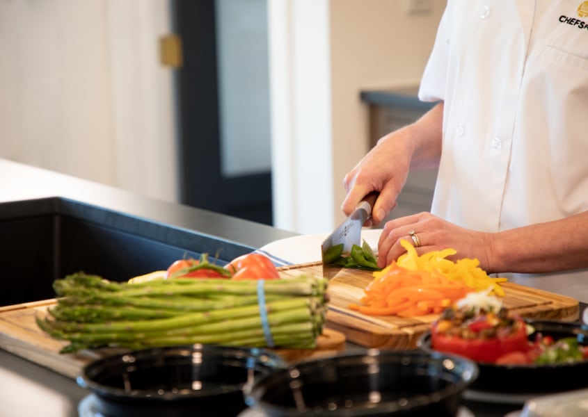 Chef chopping fresh vegetables