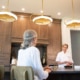 Personal chef talking with her elderly client in a home kitchen.